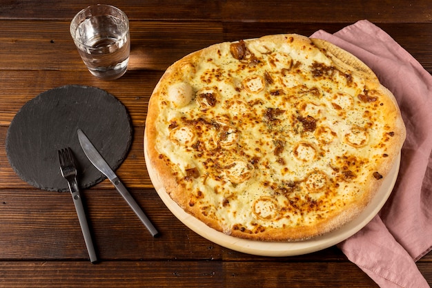 High angle pizza with cheese and cutlery