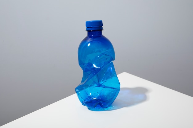 Free photo high angle plastic bottle on white table