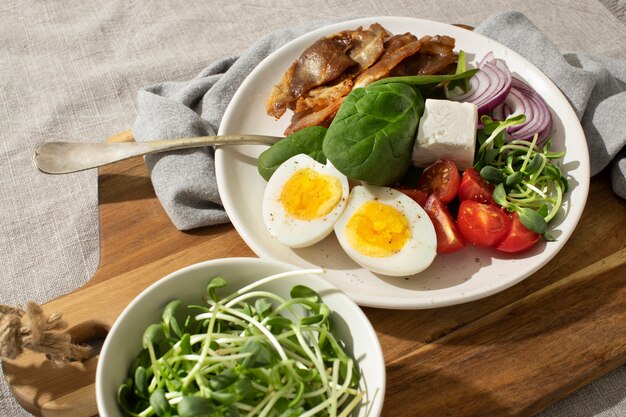 High angle of plate with keto diet food and a bowl with sprouts