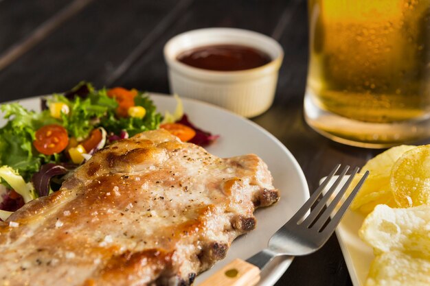 High angle of plate with steak and beer