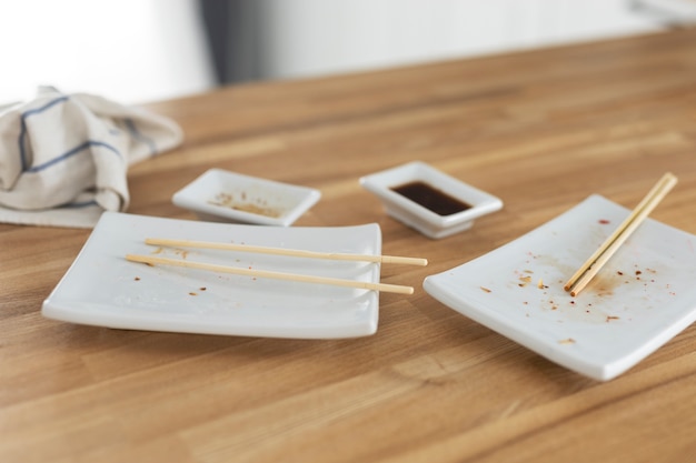 High angle plates and soy sauce on table