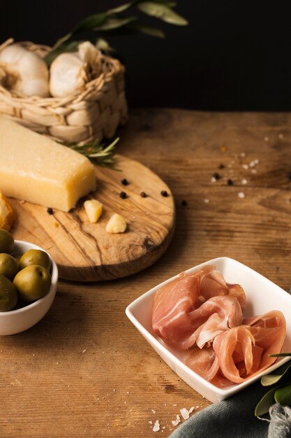 High angle prosciutto and parmesan on table