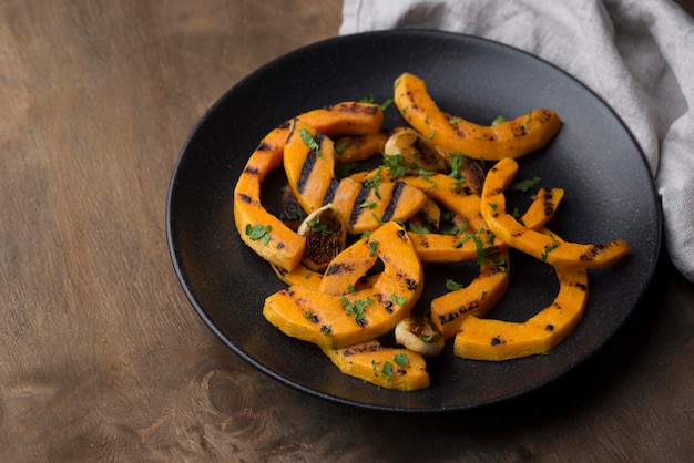 Free Photo high angle pumpkin cooked arrangement on dark plate