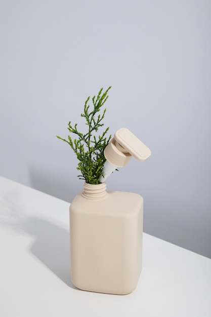 Free photo high angle recycled plastic bottle with plant