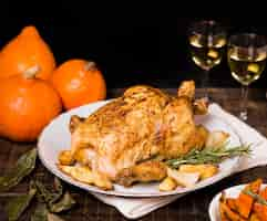 Free photo high angle of roasted chicken on plate for thanksgiving dinner