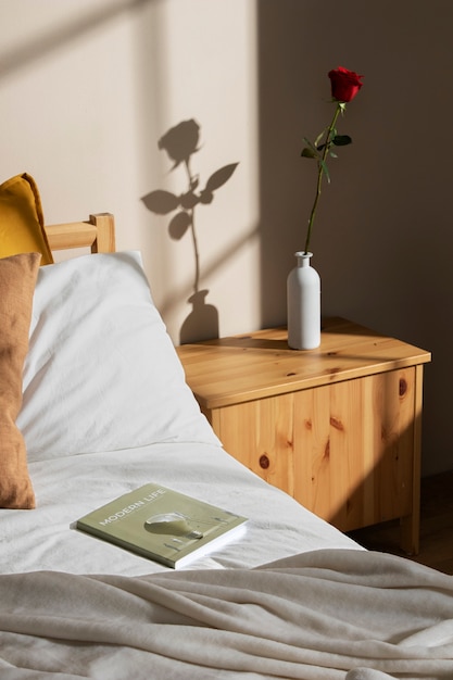 Free Photo high angle rose and book in bedroom