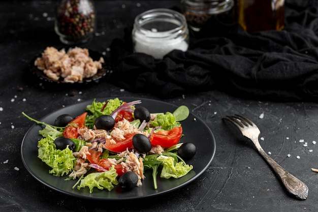 High angle salad with different ingredients on dark plate