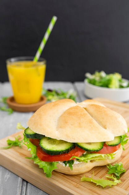 High angle of sandwich with defocused orange juice