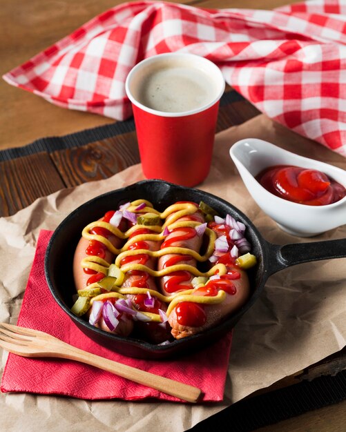 High angle sausages in pan with sauces