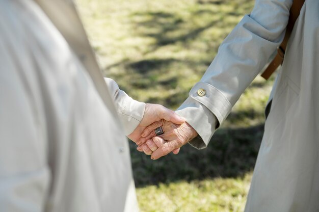 High angle senior people holding hands