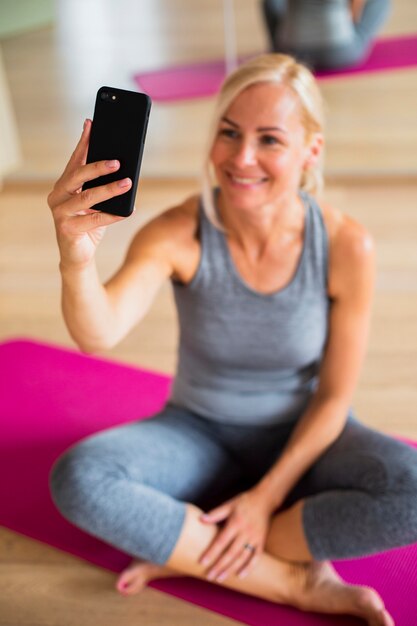 High angle senior woman taking selfie