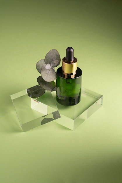 Free Photo high angle serum bottle and flower