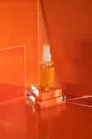 Free photo high angle serum bottle with red background