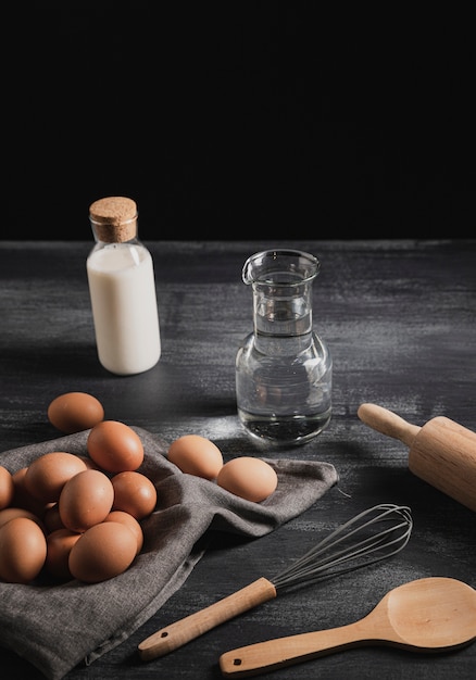 High angle set of  kitchen tools next to eggs