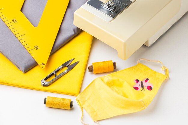 High angle of sewing machine with fabric and face mask