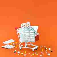 Free photo high angle of shopping cart with pill foils and copy space