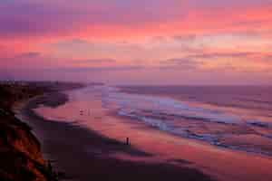 Free photo high angle shot of a beautiful beach under the breathtaking sunset sky