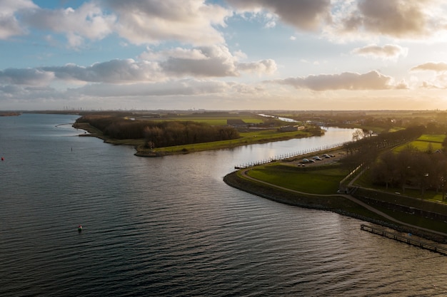 Free Photo high angle shot of a beautiful river under a cloudy sky in veere, the neverlands