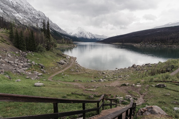 High angle shot of a clear frozen lake surrounded by a mountainous scenery