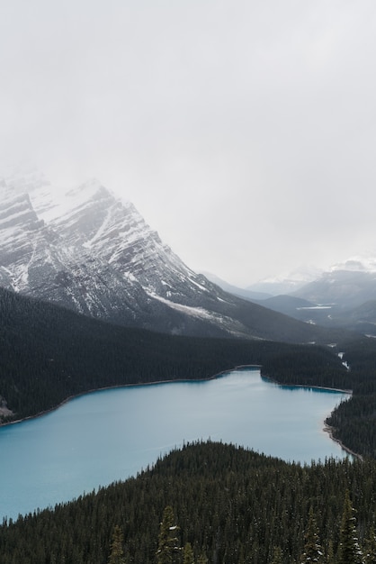 High angle shot of a clear frozen lake surrounded by a mountainous scenery