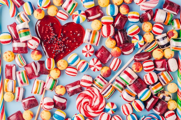 High angle shot of colorful candies and a heart-shaped lollipop - perfect for a cool wallpaper