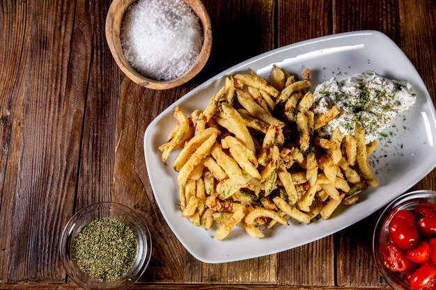 High angle shot of a delicious potato fries on a white plate