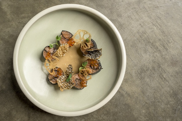 High angle shot of fusion food with sushi and seasonings in a plate on a wooden surface