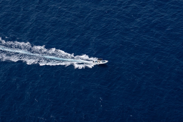 High angle shot of a motorboat sailing on the surface of the sea