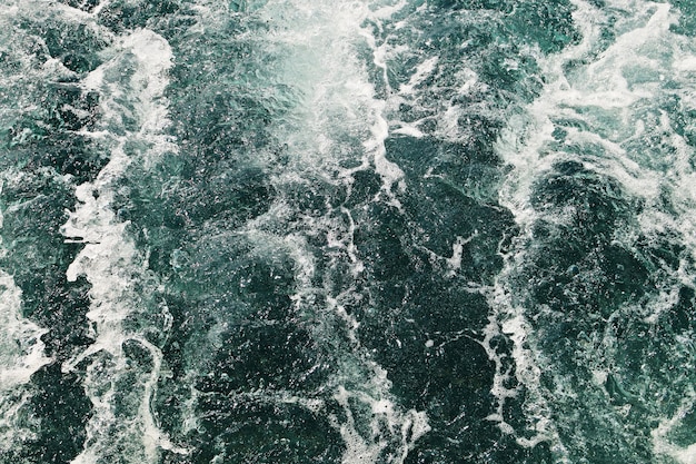 High angle shot of the ocean waves moving towards the shore