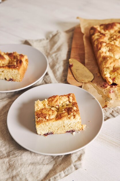 High angle shot of a piece of delicious Jerry Crumble Sheet cake on a white wood table