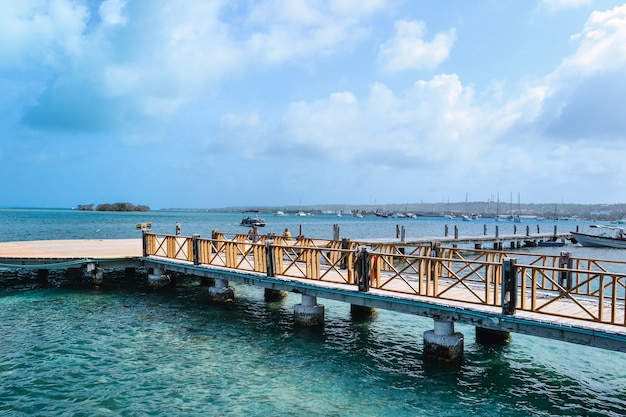 Free Photo high angle shot of a pier on the seashore with a cloudy blue sky