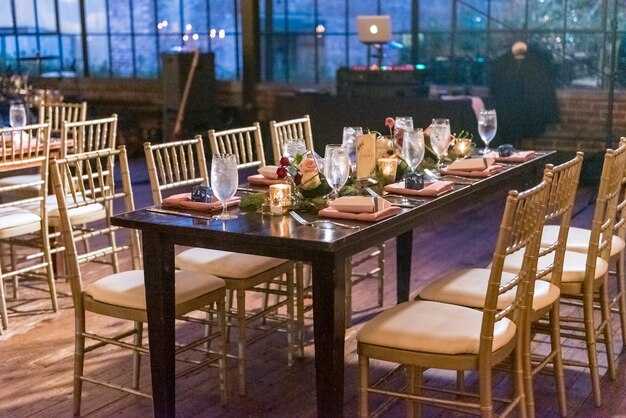 High angle shot of a table with an elegant setting in the restaurant hall in the evening