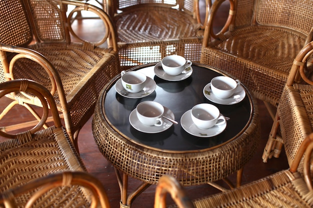 Free photo high angle shot of a tea set on a table with chairs