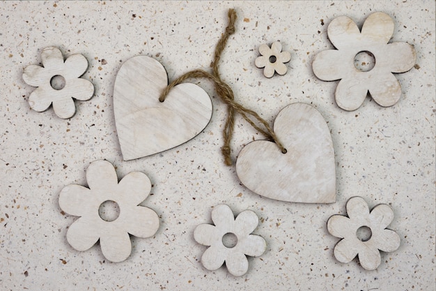 Free photo high angle shot of wooden heart-shaped ornaments with flowers