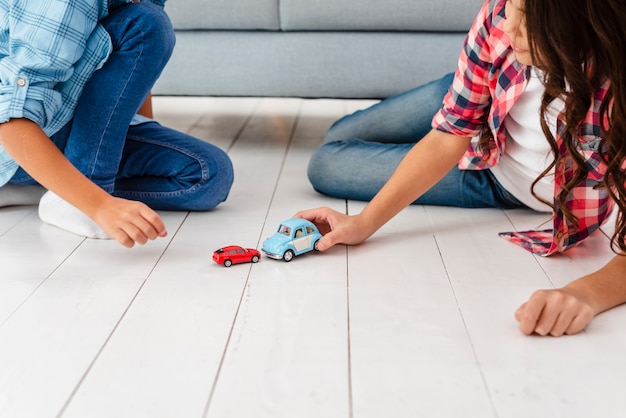 Free photo high angle siblings playing with toys