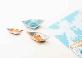 Free photo high angle small paper world map boats