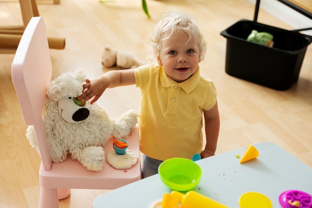 High angle smiley kid with toy