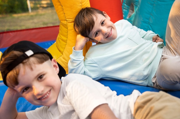 High angle smiley kids laying in bounce house