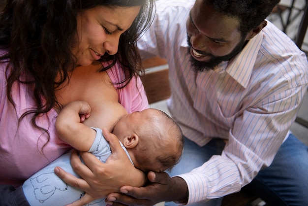 High angle smiley woman breastfeeding