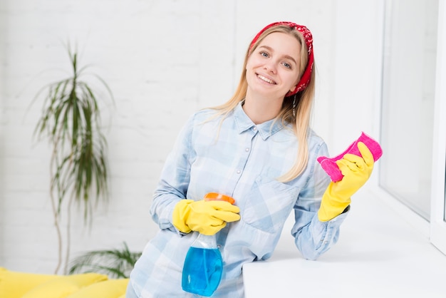 High angle smiley woman cleaning