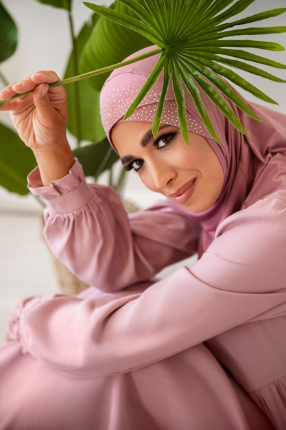 High angle smiley woman holding green leaf