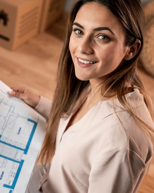 High angle smiley woman with plan