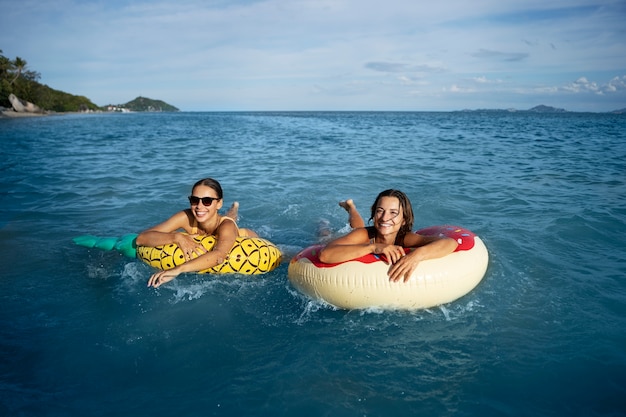 High angle smiley women on floaters