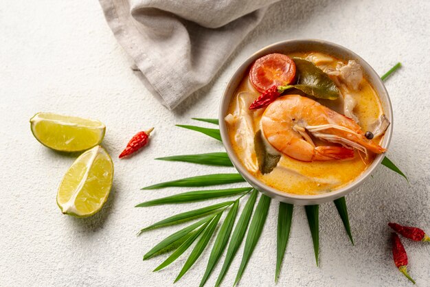 High angle soup in bowl with shrimp and lemon