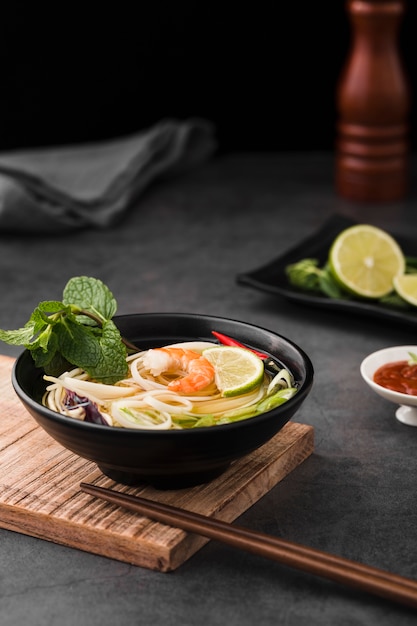 High angle of soup with noodles and chopsticks