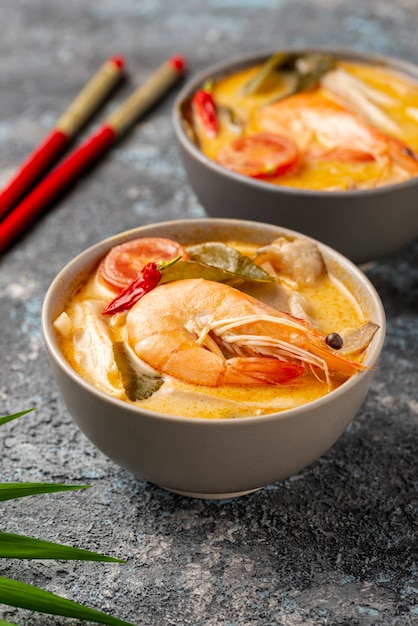 Free photo high angle soups in bowls with shrimp and chopsticks