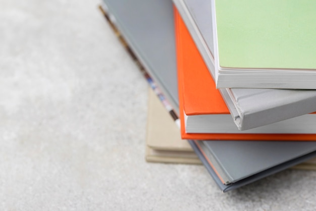 Free Photo high angle of stacked books on the table