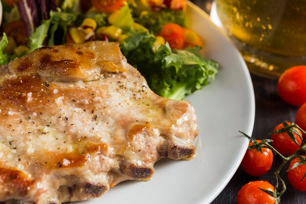 High angle of steak on plate with beer