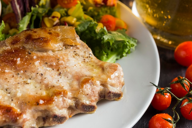 High angle of steak on plate with beer