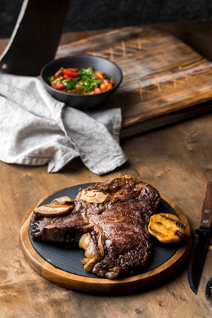 Free photo high angle of steak on plate with cutlery